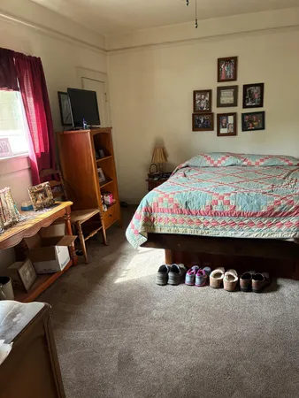 a bed room with a bed and a chair
