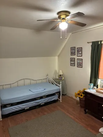 a bedroom with bed and a chandelier
