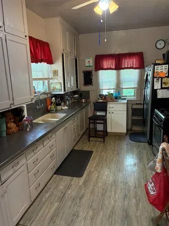 a kitchen with sink cabinets and wooden floor