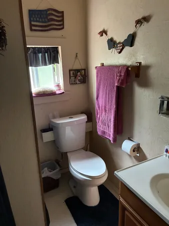 a white toilet sitting next to a bathroom sink
