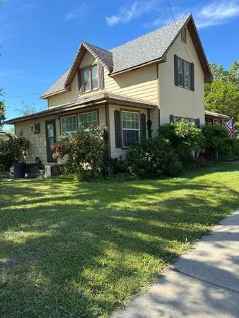 a front view of a house with garden