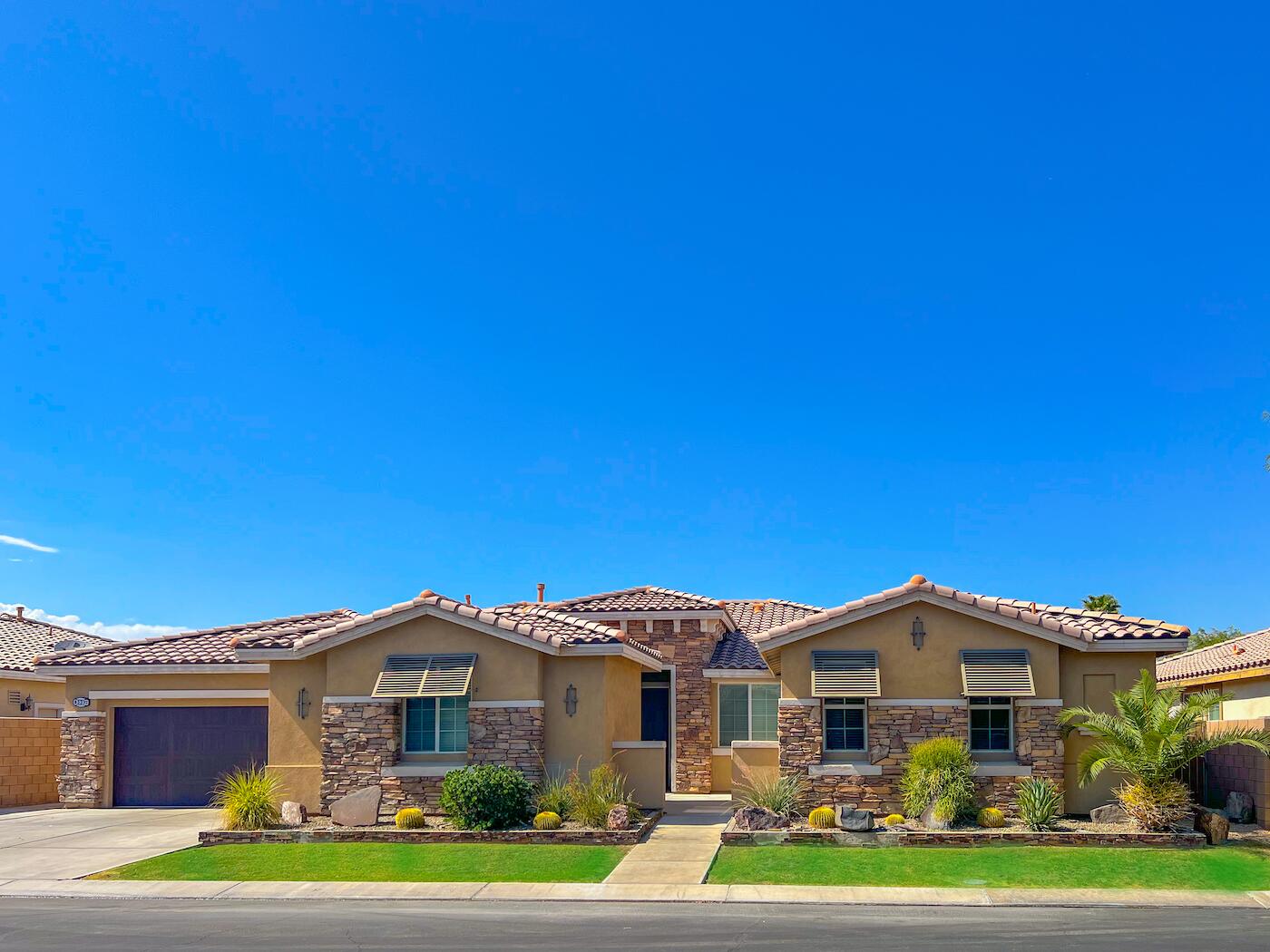 83332 Lone Star Road Indio, CA 92203 - Photo 2 of 33 a front view of a house with a garden