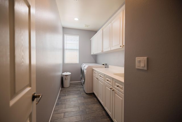 a kitchen with cabinets a sink and a window