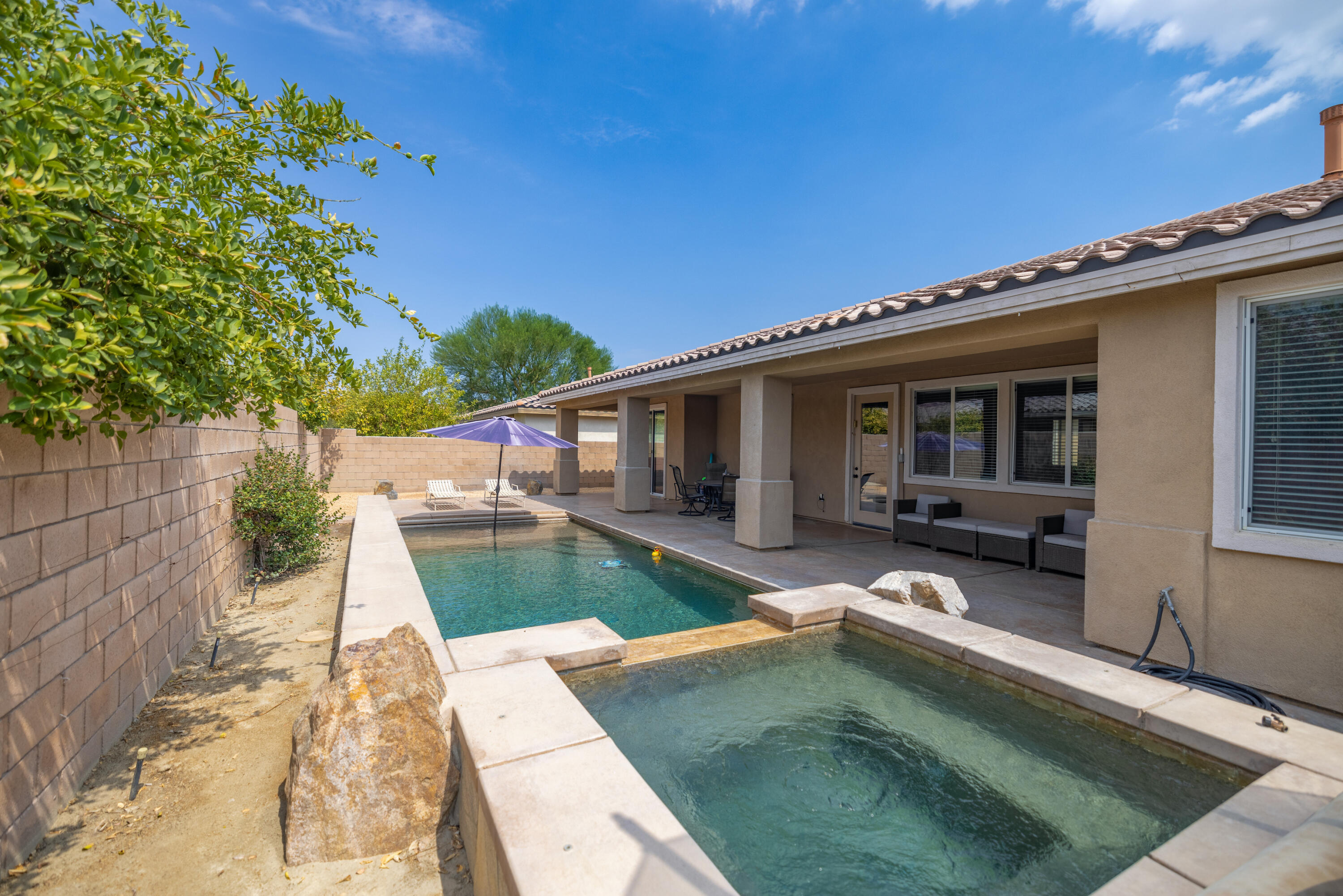 83332 Lone Star Road Indio, CA 92203 - Photo 30 of 33 a view of a house with backyard sitting area and porch