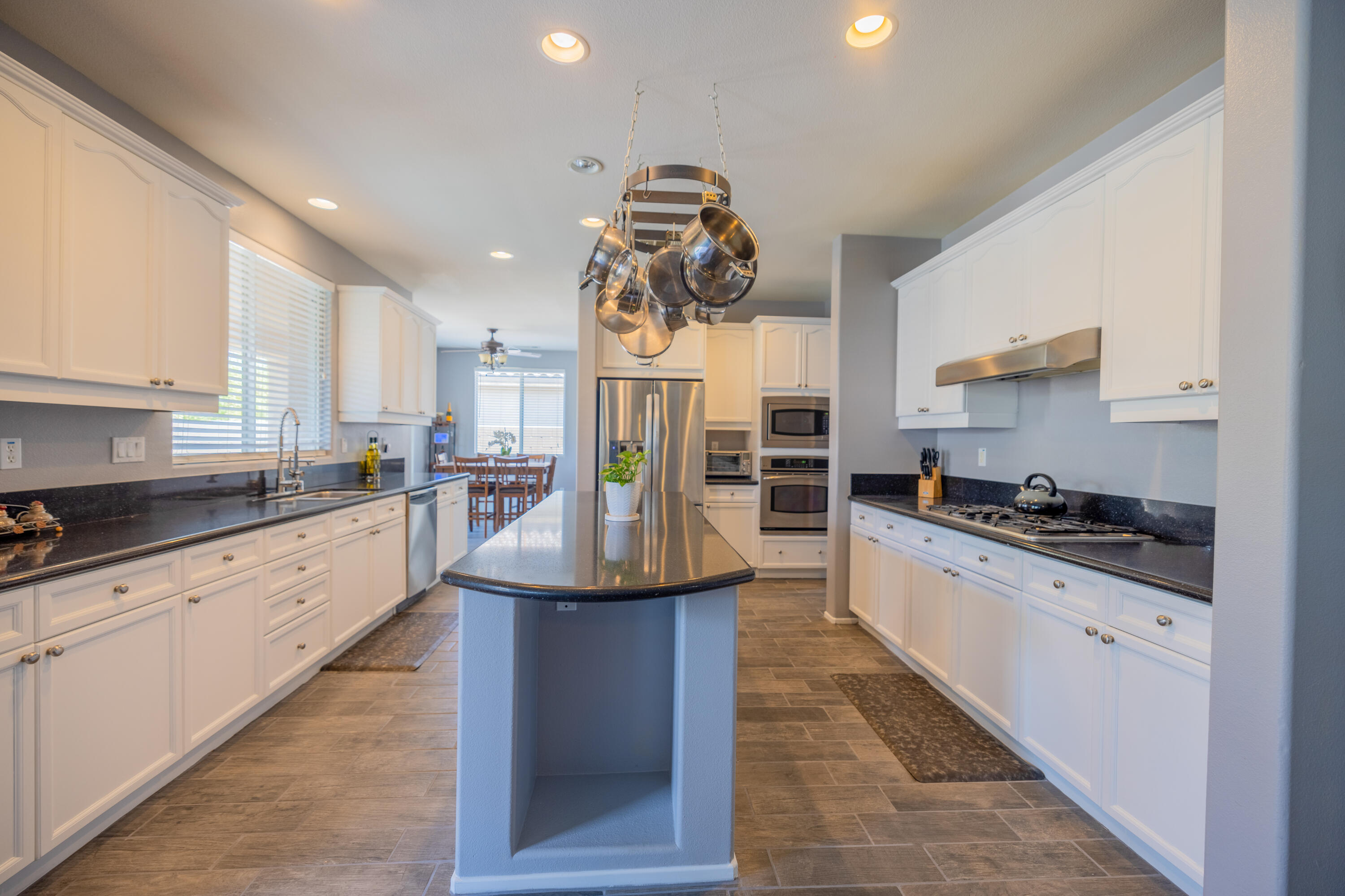 83332 Lone Star Road Indio, CA 92203 - Photo 6 of 33 a kitchen with stainless steel appliances granite countertop a sink stove and refrigerator