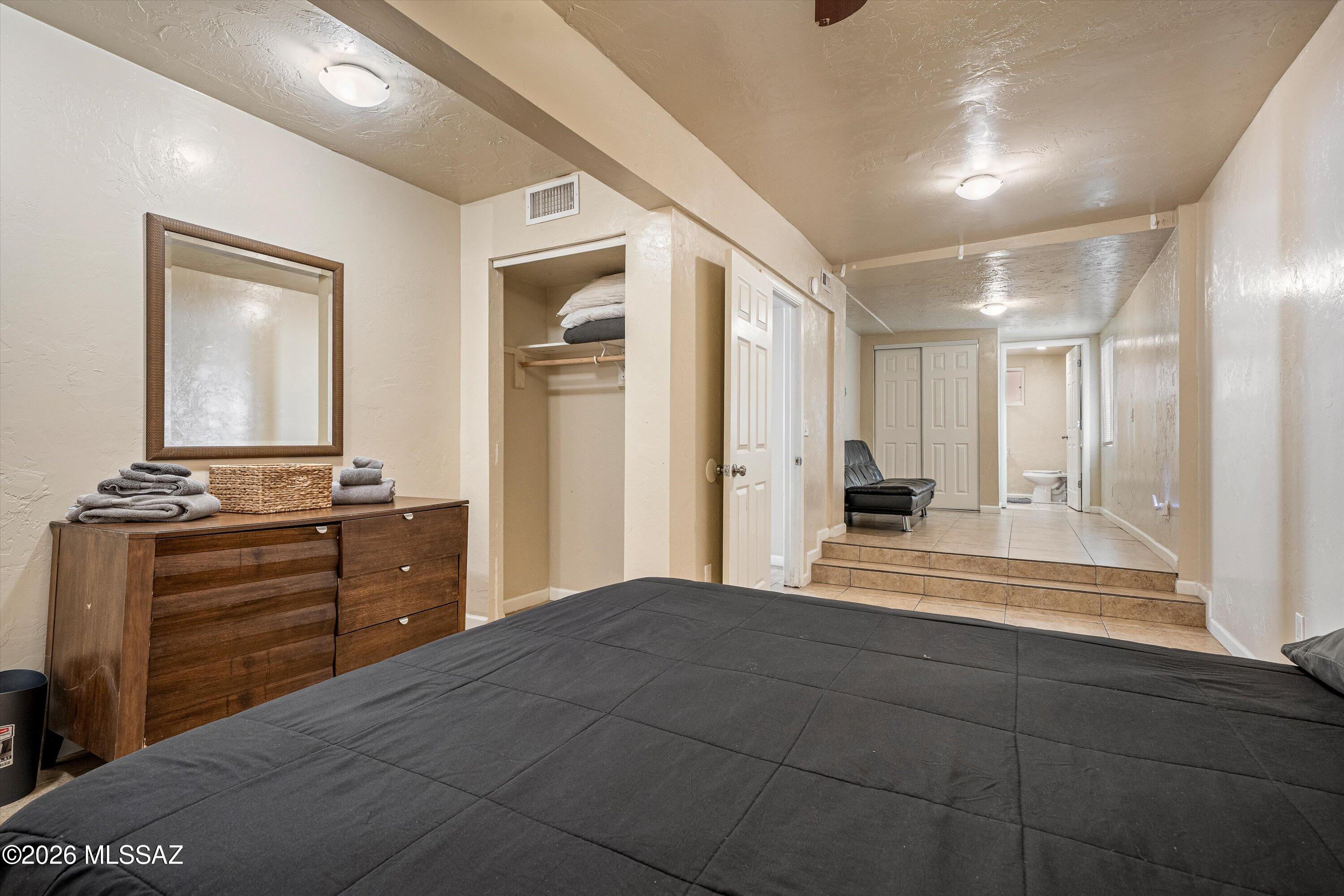 2619 East Prince Road Tucson, AZ 85716 - Photo 45 of 50 a large bedroom with a bed and a dresser