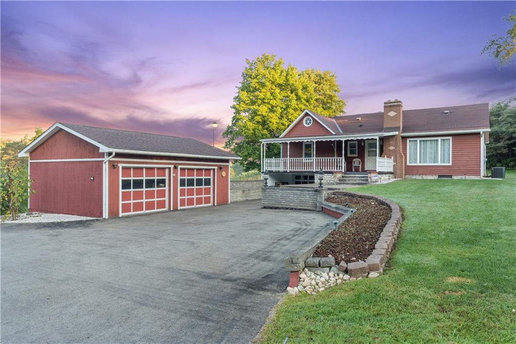 355 Highway 31 Ruffs Dale, PA 15679 - Photo 1 of 25 a front view of a house with a yard and garage