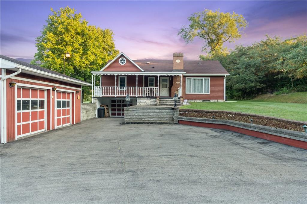 355 Highway 31 Ruffs Dale, PA 15679 - Photo 2 of 25 a front view of a house with a yard and garage