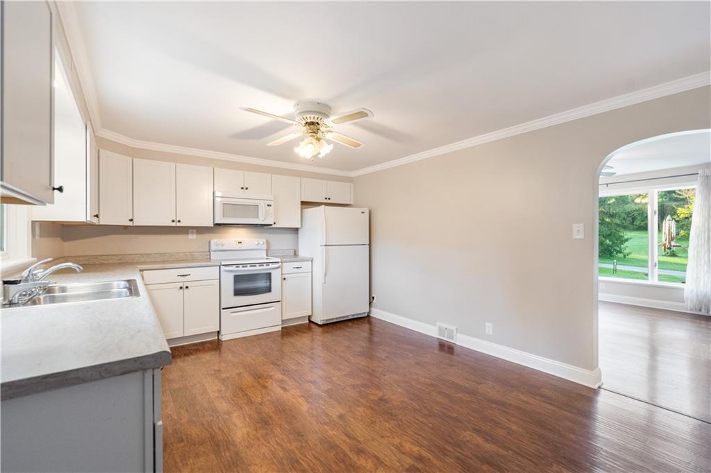 355 Highway 31 Ruffs Dale, PA 15679 - Photo 12 of 25 a kitchen with a sink cabinets stainless steel appliances and a window