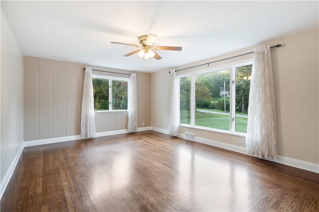355 Highway 31 Ruffs Dale, PA 15679 - Photo 8 of 25 a view of an empty room with wooden floor and a window