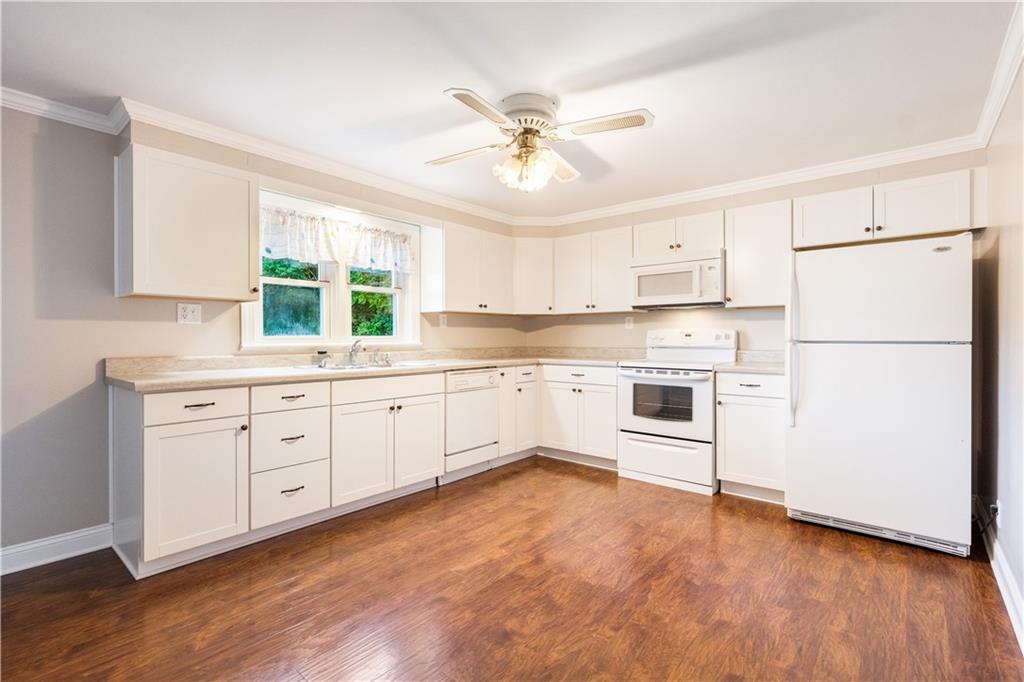 355 Highway 31 Ruffs Dale, PA 15679 - Photo 10 of 25 a kitchen with white cabinets and white appliances