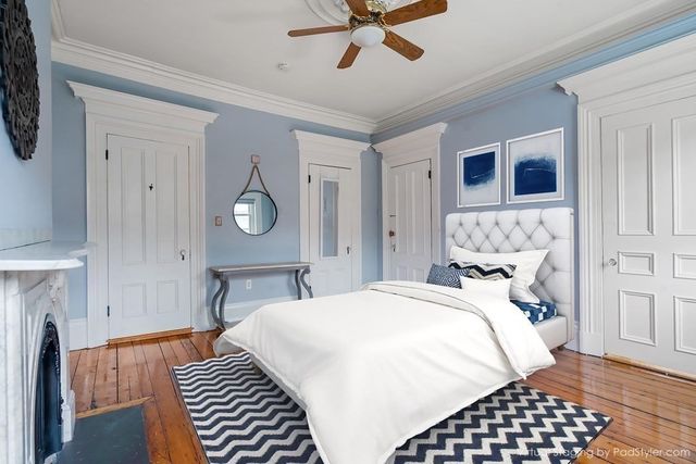 a bedroom with a bed and wooden floor