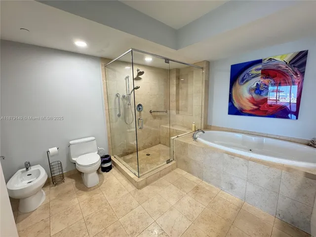 a spacious bathroom with a toilet a sink and bathtub