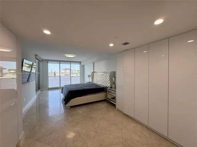 a spacious bedroom with a bed and a window