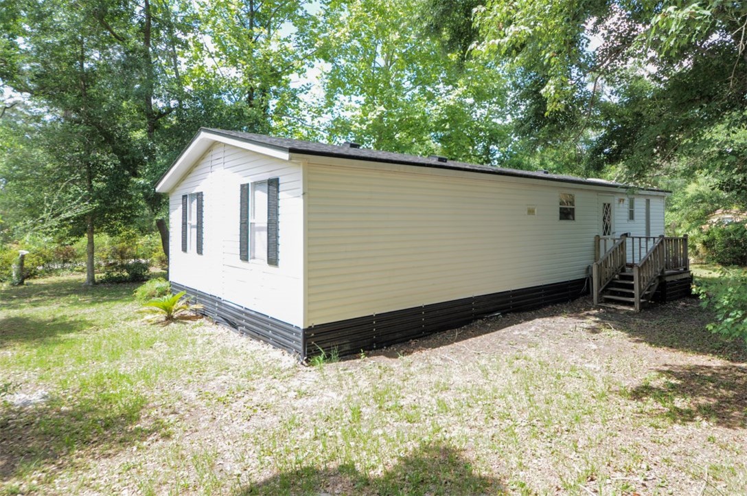 96019 Durden Road Yulee, FL 32097 - Photo 4 of 23 a view of a house with a yard