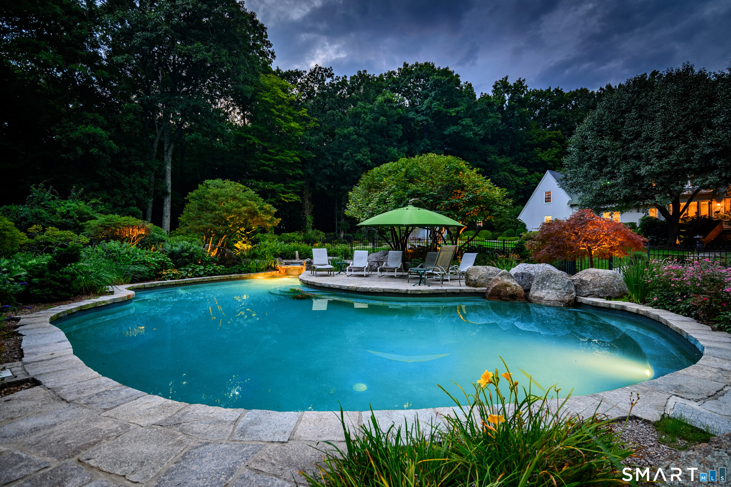 16 Winding Brook Road Newtown, CT 06470 - Photo 33 of 39 Resort-style pool surrounded by lush landscaping.