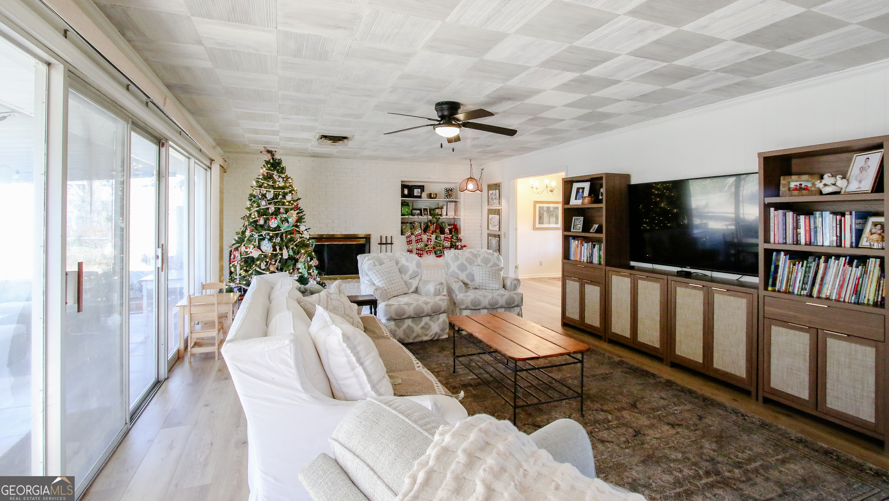 813 Evergreen Road Cobbtown, GA 30420 - Photo 13 of 72 a living room with furniture a flat screen tv and a floor to ceiling window