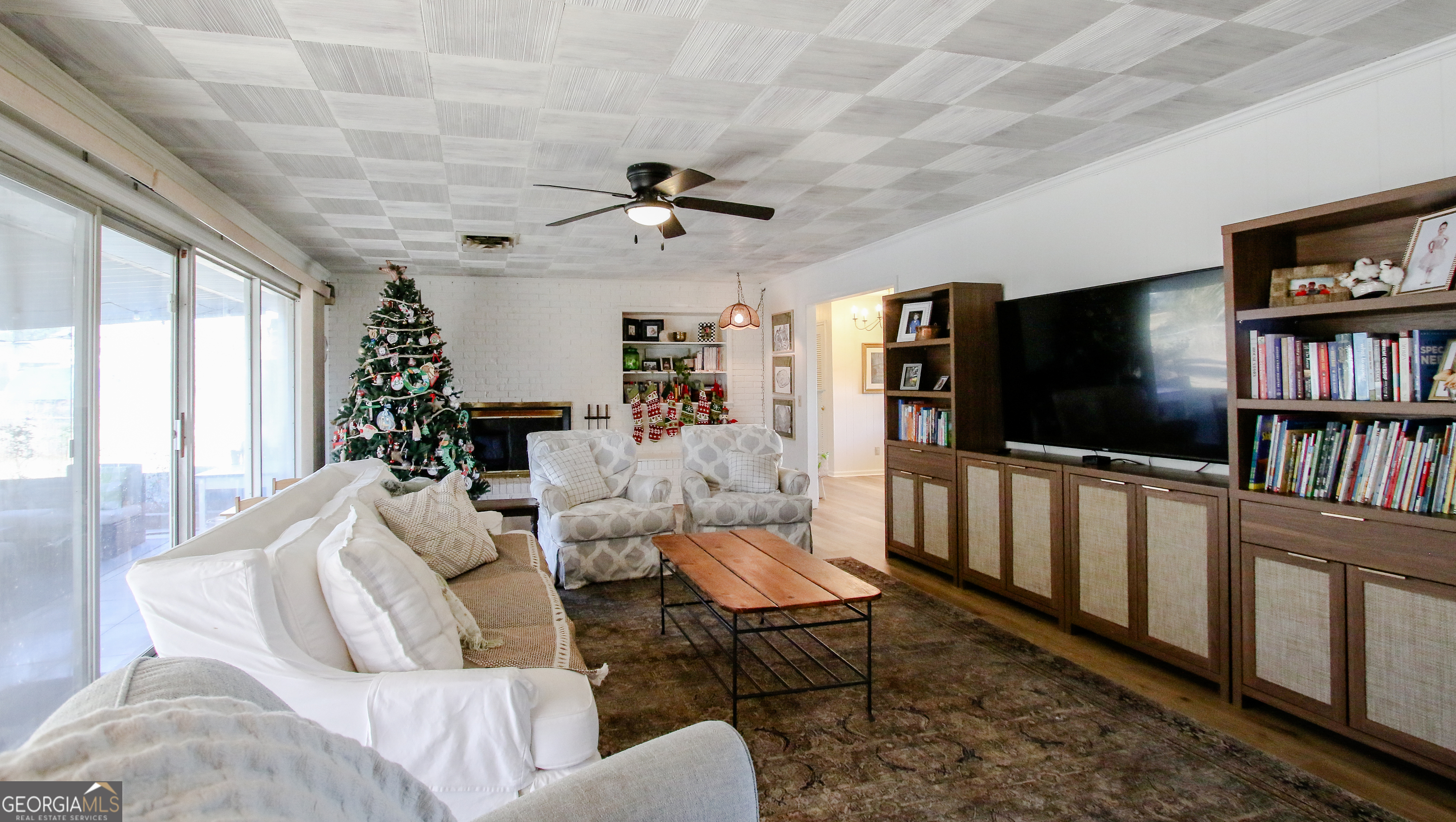 813 Evergreen Road Cobbtown, GA 30420 - Photo 14 of 72 a living room with furniture a flat screen tv and a bookshelf