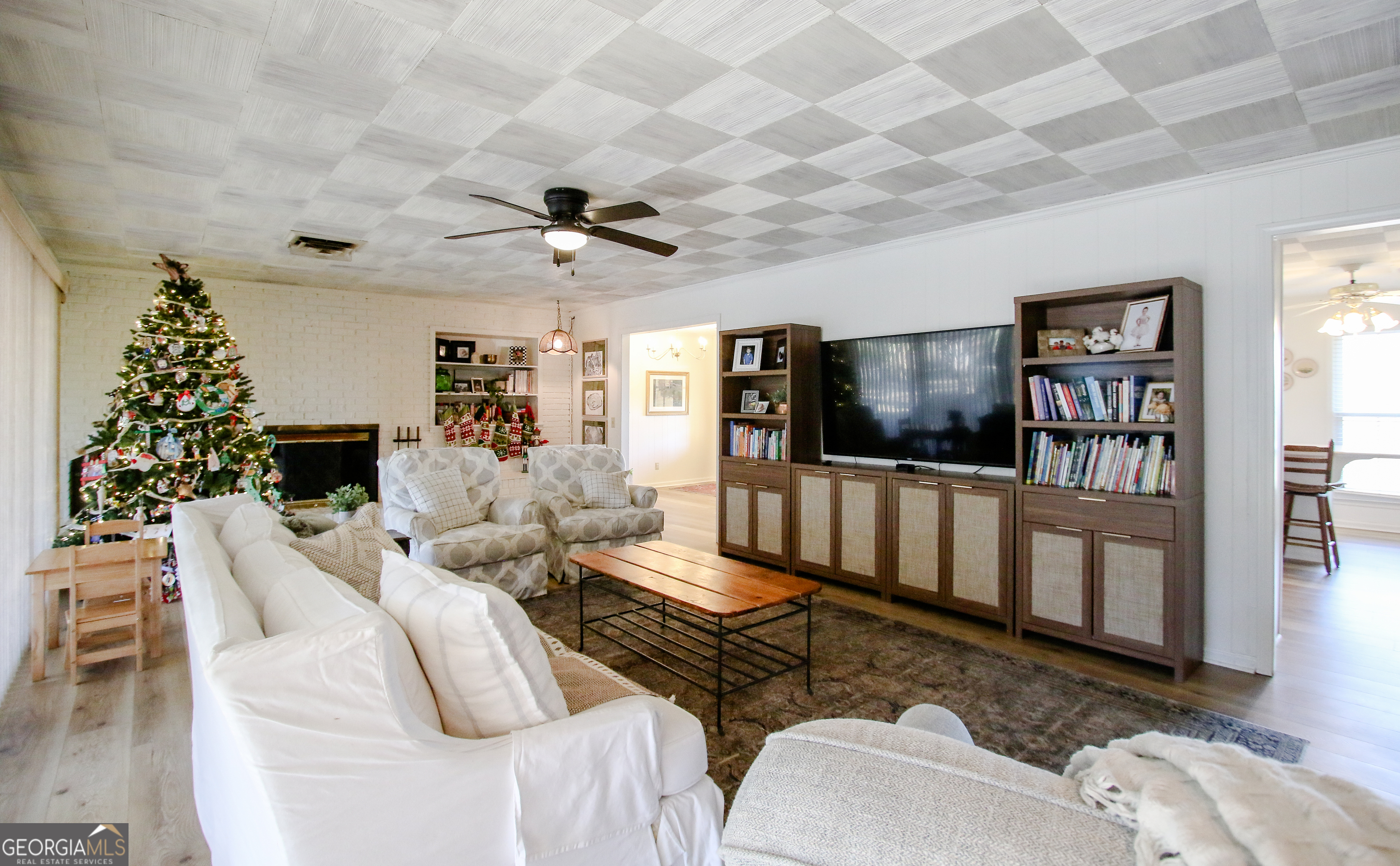813 Evergreen Road Cobbtown, GA 30420 - Photo 21 of 72 a living room with furniture a flat screen tv and a bookshelf