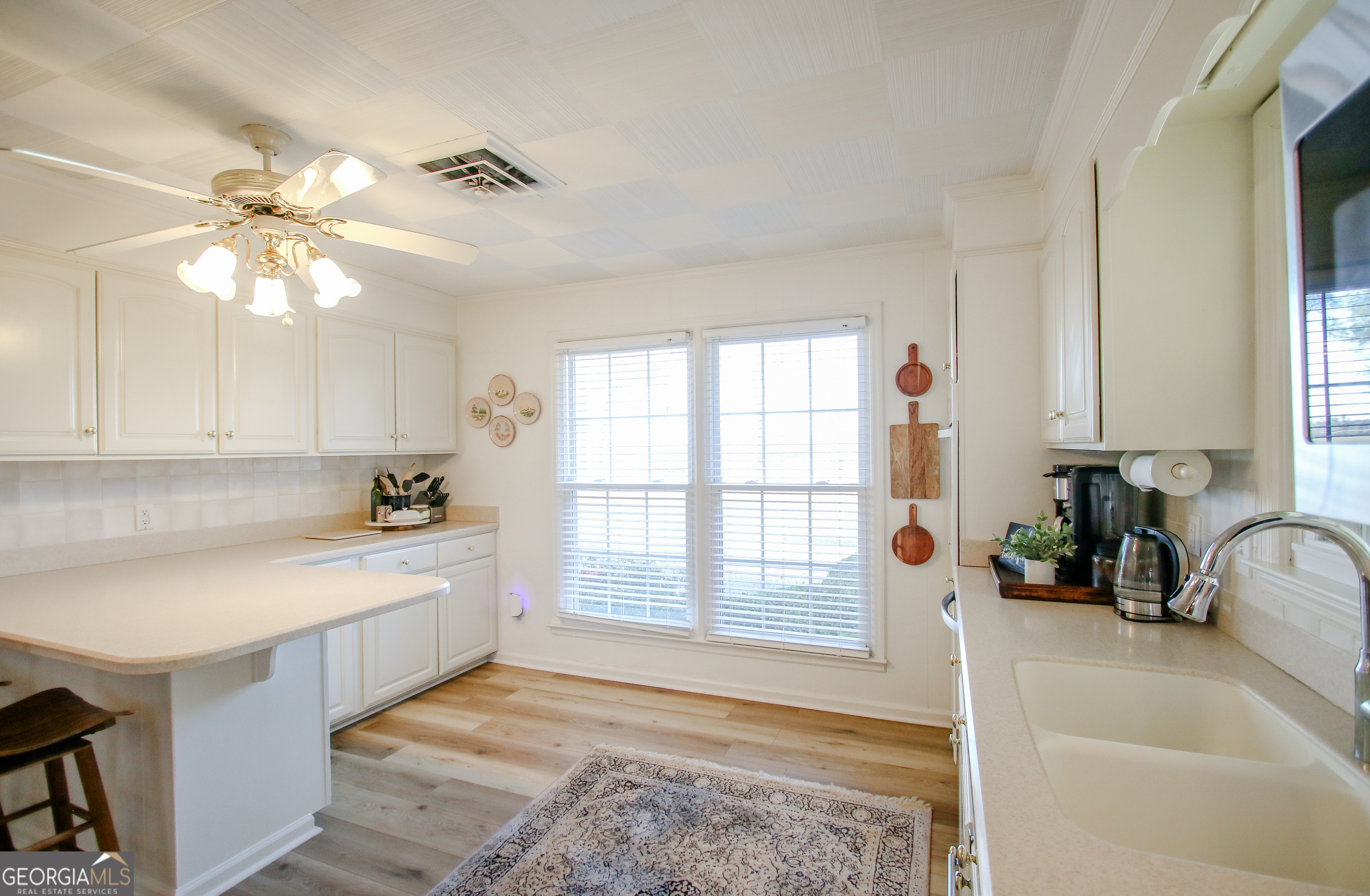 813 Evergreen Road Cobbtown, GA 30420 - Photo 27 of 72 a view of a kitchen with a sink and dishwasher with a fireplace