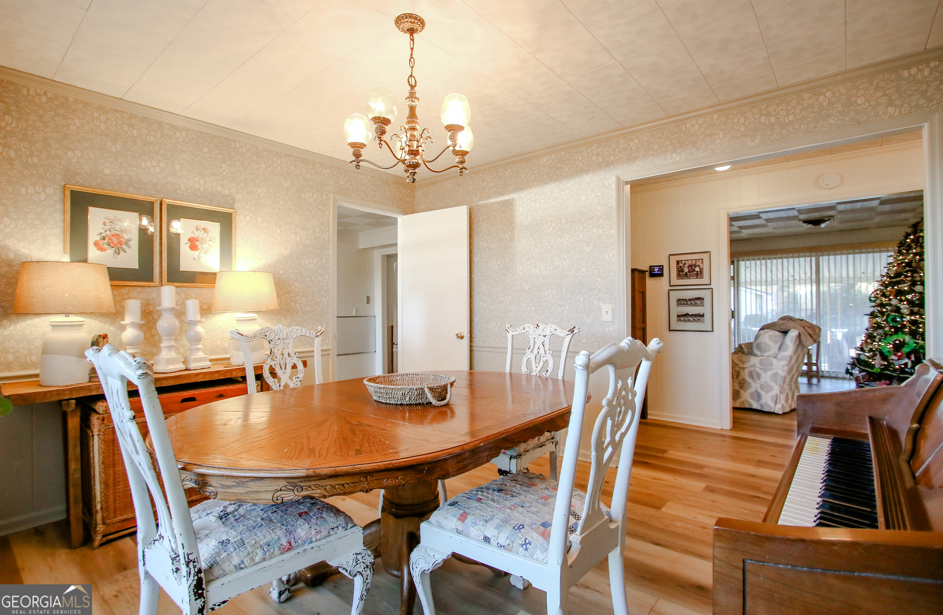 813 Evergreen Road Cobbtown, GA 30420 - Photo 34 of 72 a dining room with furniture a chandelier and wooden floor