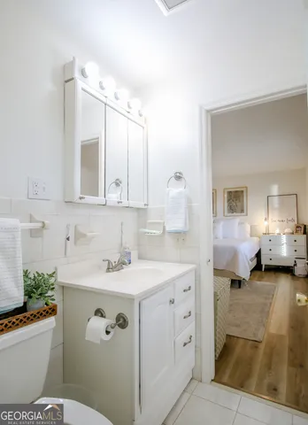 a bed room with a bed mirror and a window