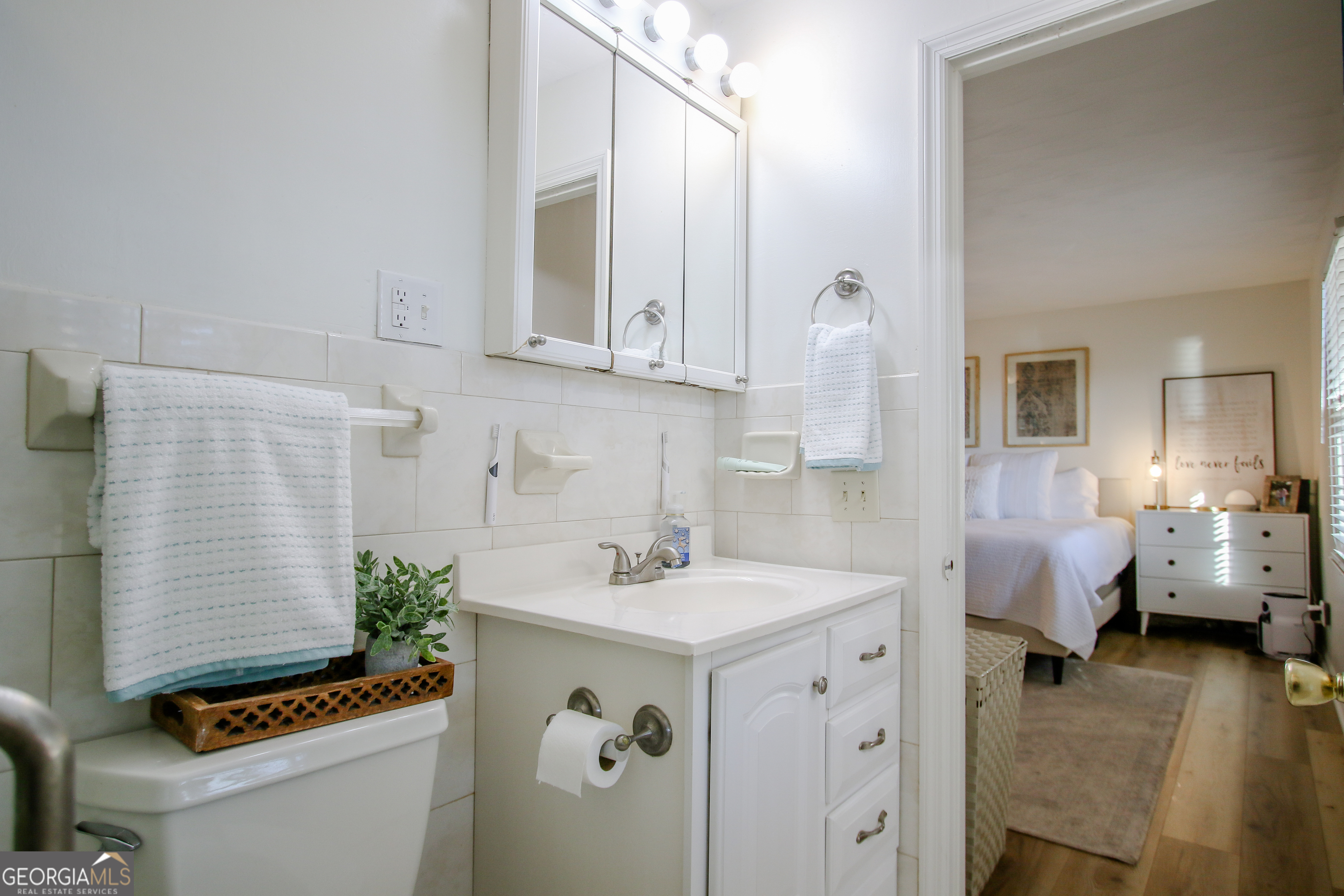813 Evergreen Road Cobbtown, GA 30420 - Photo 40 of 72 a bathroom with a sink double vanity and a toilet