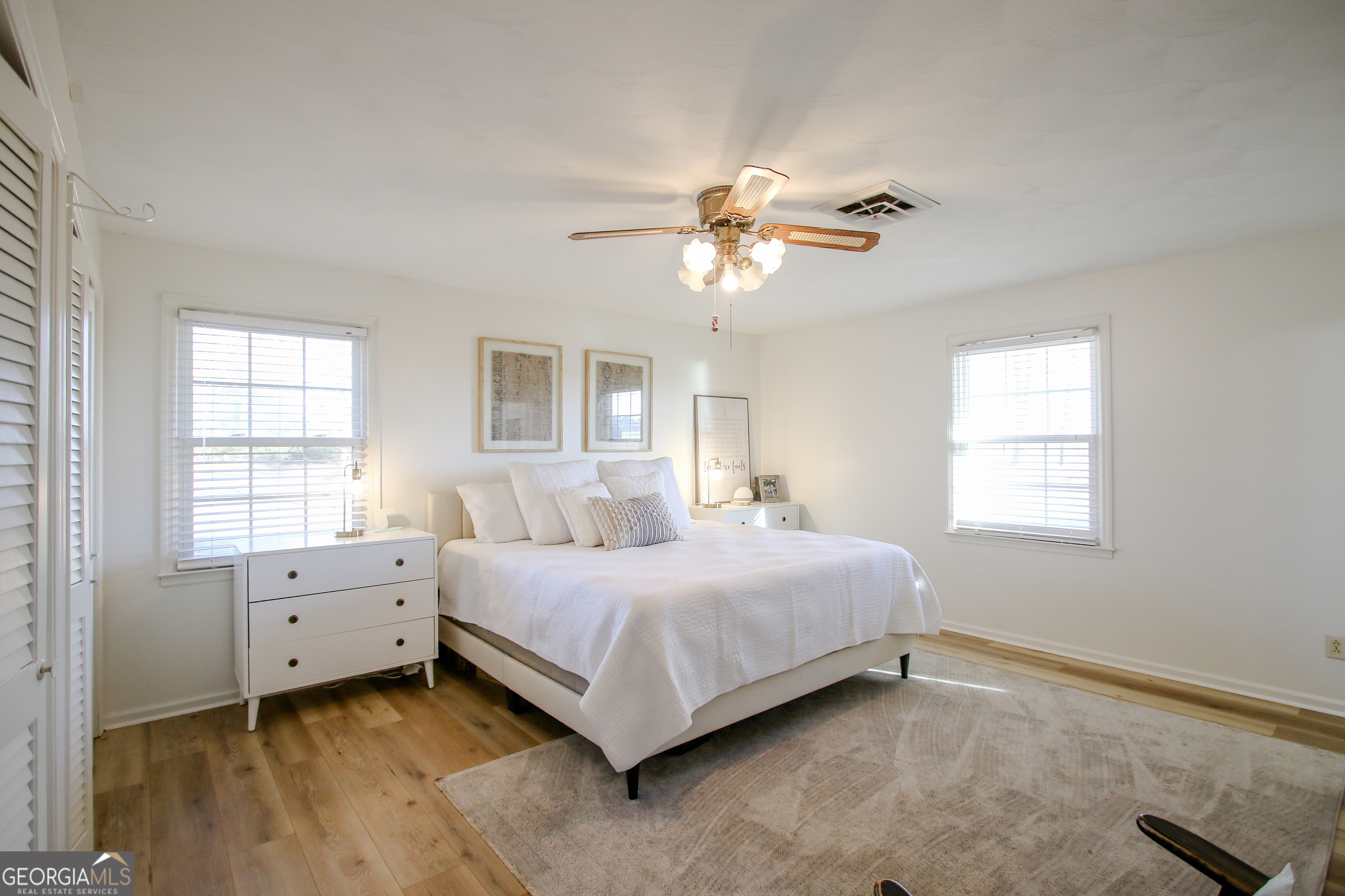 813 Evergreen Road Cobbtown, GA 30420 - Photo 42 of 72 a bedroom with a bed chandelier and a window