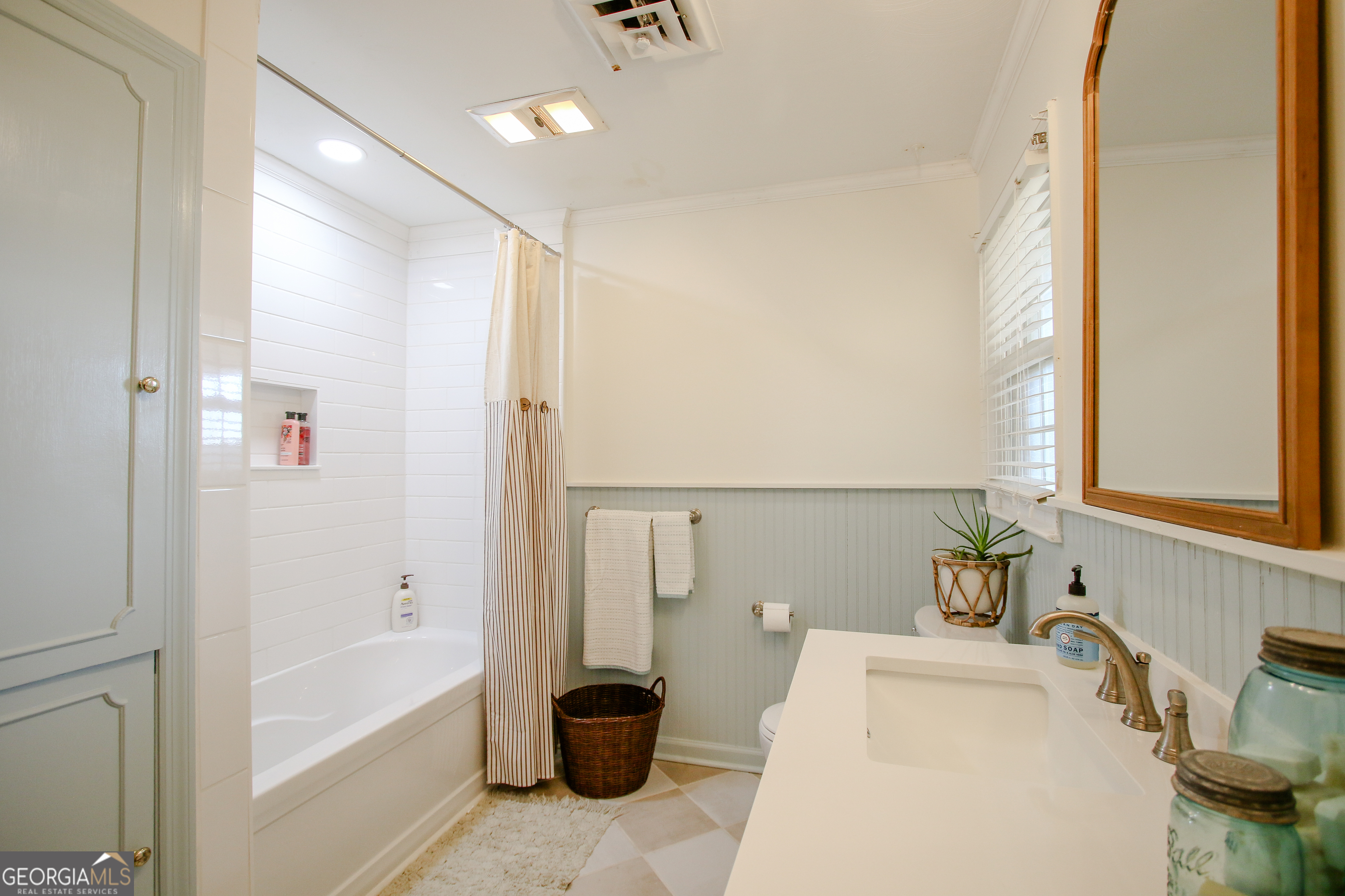 813 Evergreen Road Cobbtown, GA 30420 - Photo 59 of 72 a bathroom with a tub a sink and a large mirror