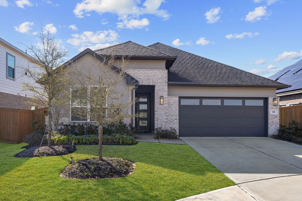 116 Solana Point Drive Katy, TX 77493 - Photo 2 of 30 a front view of a house with a garden and yard