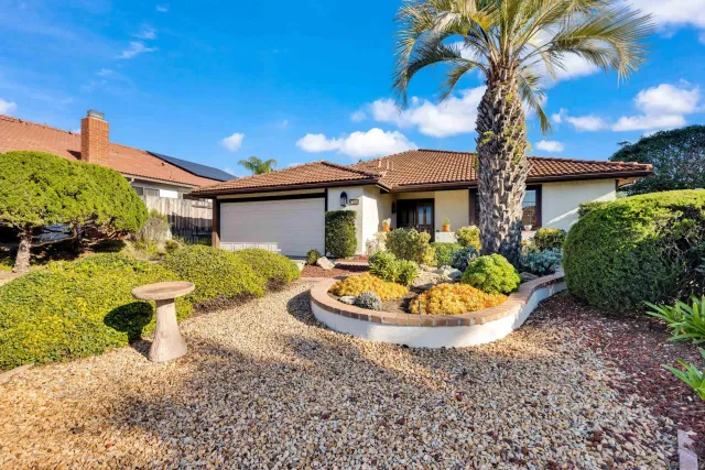 a front view of a house with a yard garage and outdoor seating