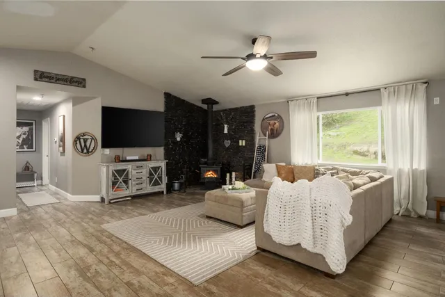 a spacious bedroom with a bed and a flat screen tv