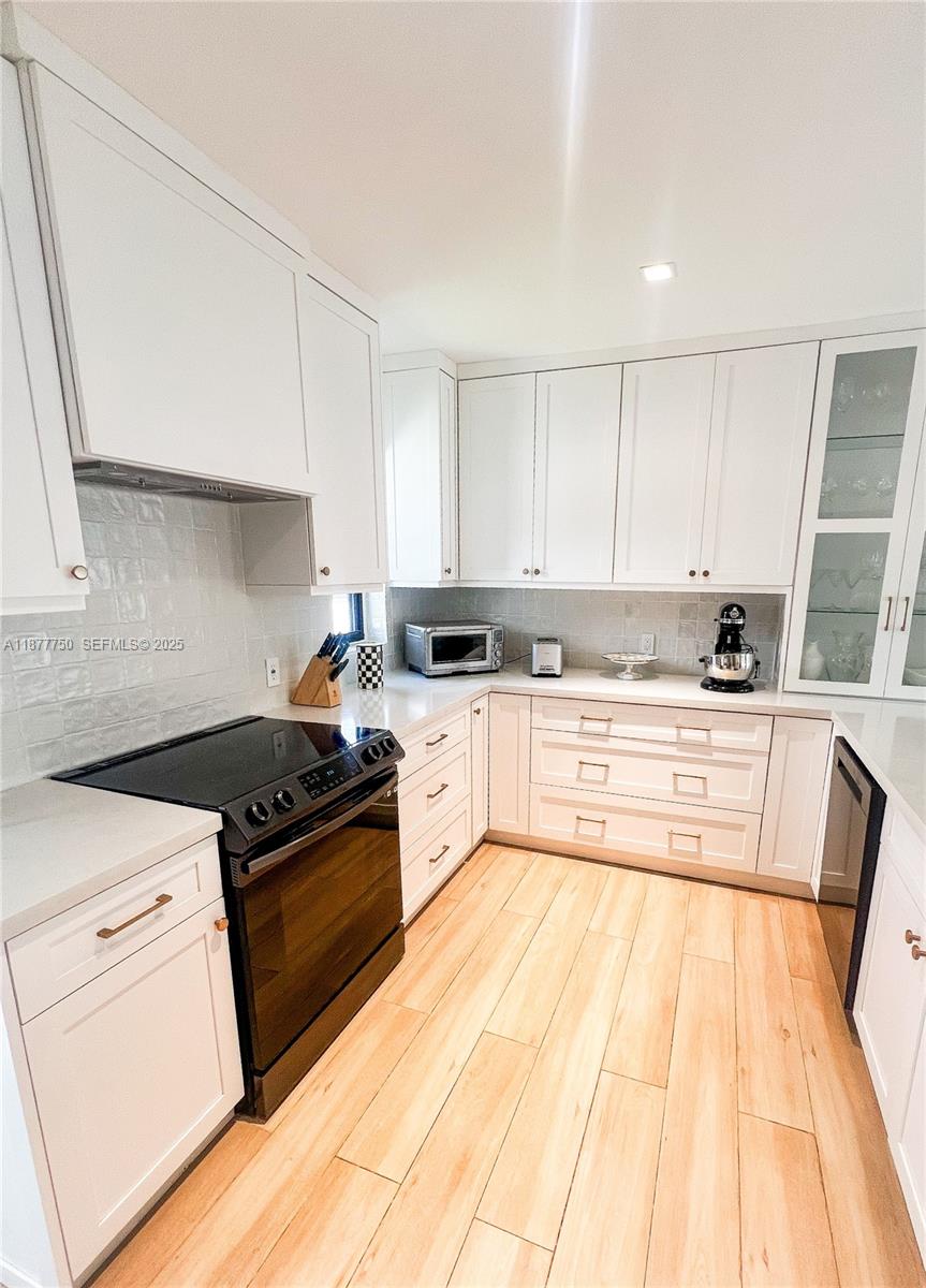 1600 Southwest 17th Avenue Miami, FL 33145 - Photo 17 of 32 a kitchen with granite countertop white cabinets and white appliances