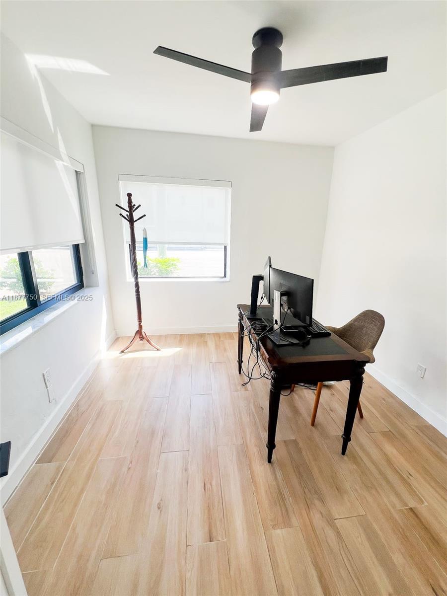 1600 Southwest 17th Avenue Miami, FL 33145 - Photo 18 of 32 a view of a workspace with furniture and wooden floor