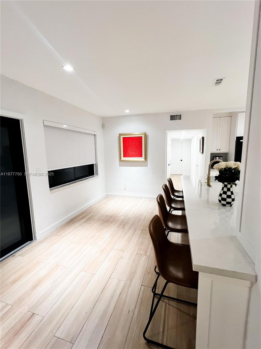 1600 Southwest 17th Avenue Miami, FL 33145 - Photo 5 of 32 a view of a workspace with furniture and wooden floor