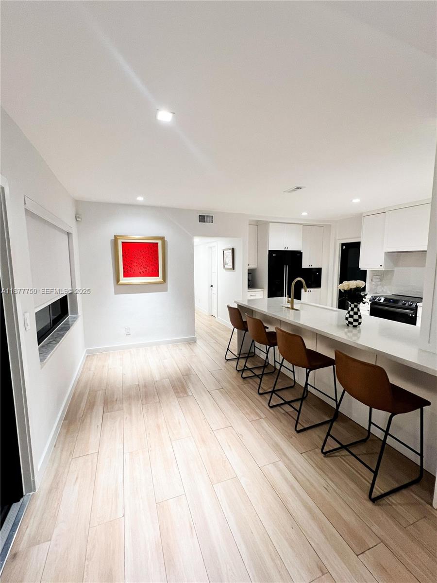 1600 Southwest 17th Avenue Miami, FL 33145 - Photo 8 of 32 a living room with stainless steel appliances kitchen island wooden floor and view living room