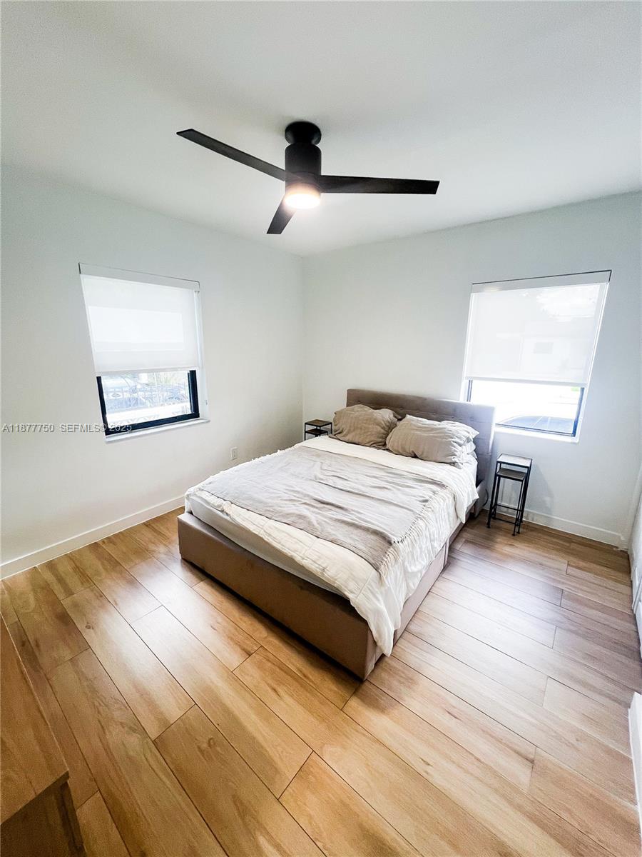 1600 Southwest 17th Avenue Miami, FL 33145 - Photo 9 of 32 a bedroom with a bed and wooden floor