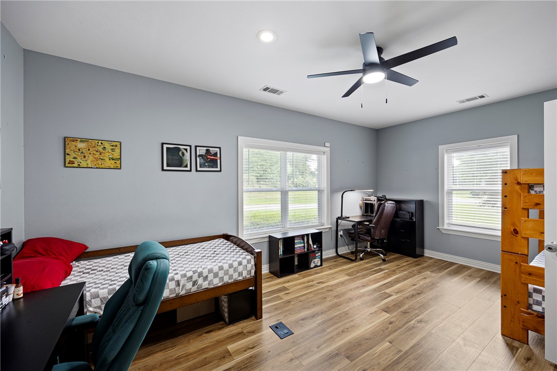 751 Walthall Road Russellville, AR 72802 - Photo 25 of 60 Spacious room featuring wood-finish flooring, light blue walls, and multiple windows