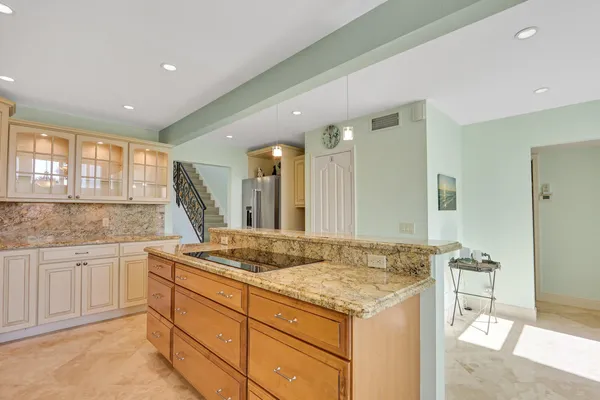 a kitchen with granite countertop white cabinets stainless steel appliances and sink