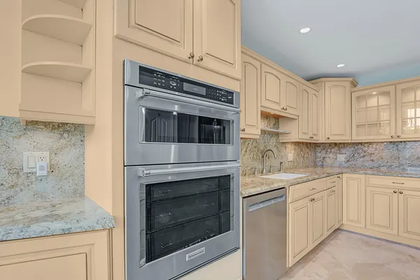 a kitchen with stainless steel appliances granite countertop a sink and cabinets