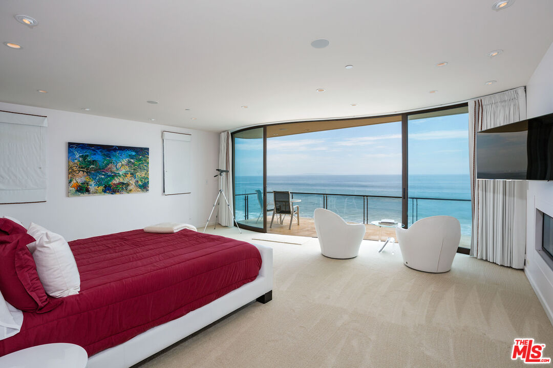 24230 Malibu Road Malibu, CA 90265 - Photo 16 of 27 a bedroom with a large bed and a large window