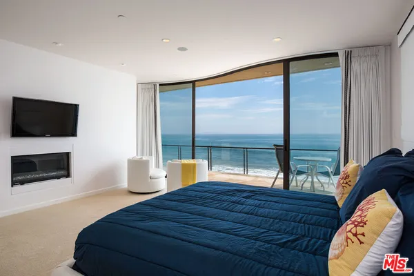 a bedroom with a bed and glass window