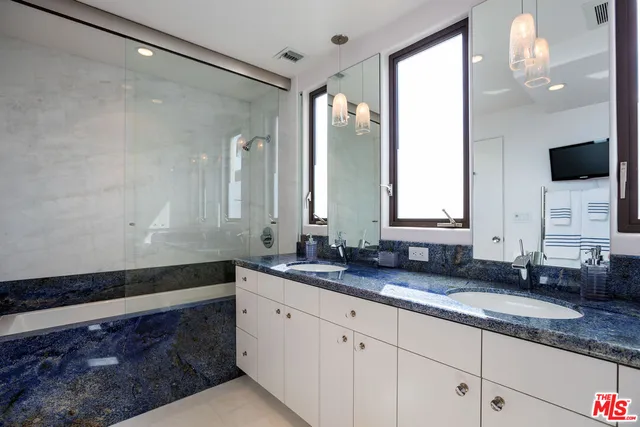 a bathroom with a double vanity sink and a mirror