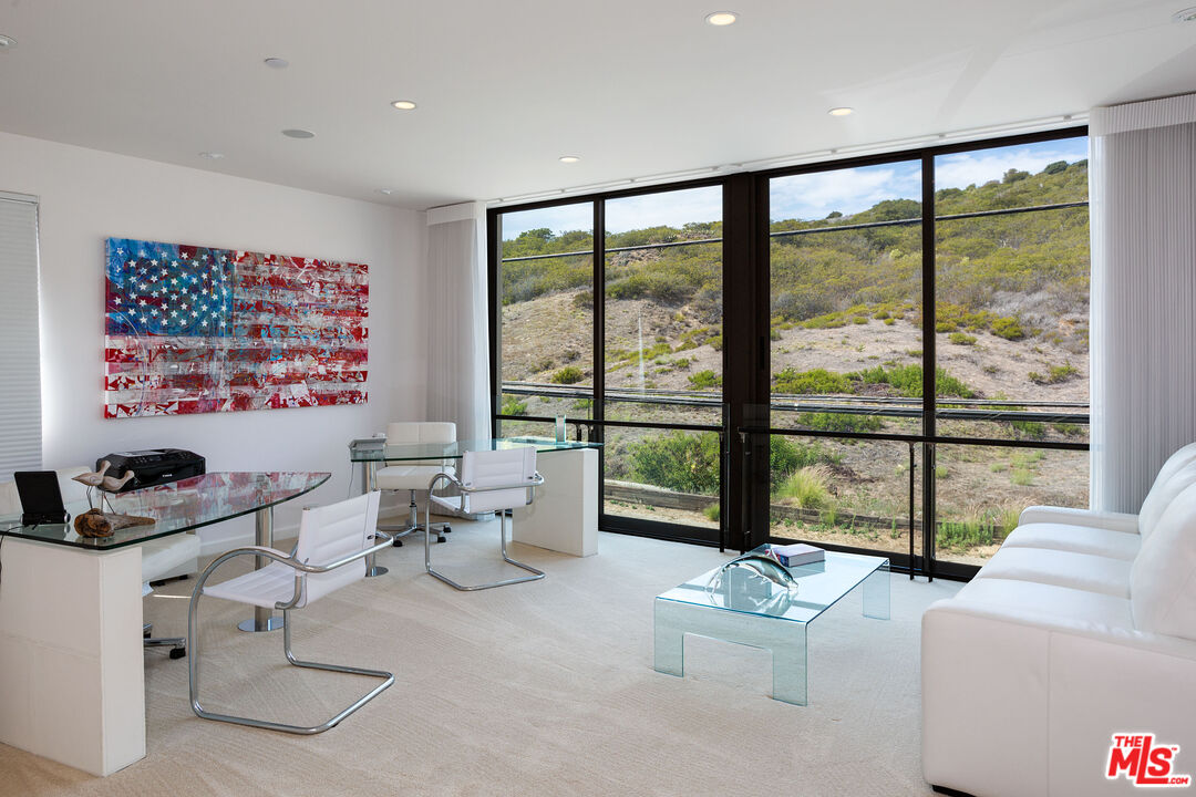 24230 Malibu Road Malibu, CA 90265 - Photo 25 of 27 a living room with furniture and large windows