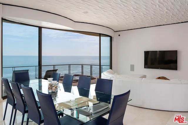 a view of a dining room with furniture window and outside view