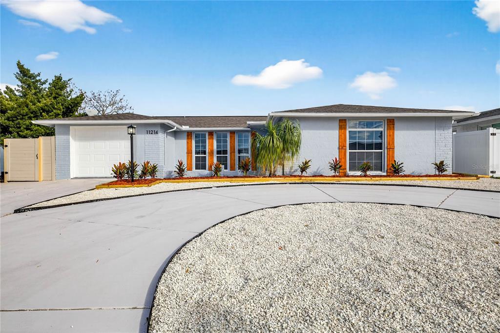 11214 Kapok Avenue Port Richey, FL 34668 - Photo 1 of 25 front view of a house with a patio