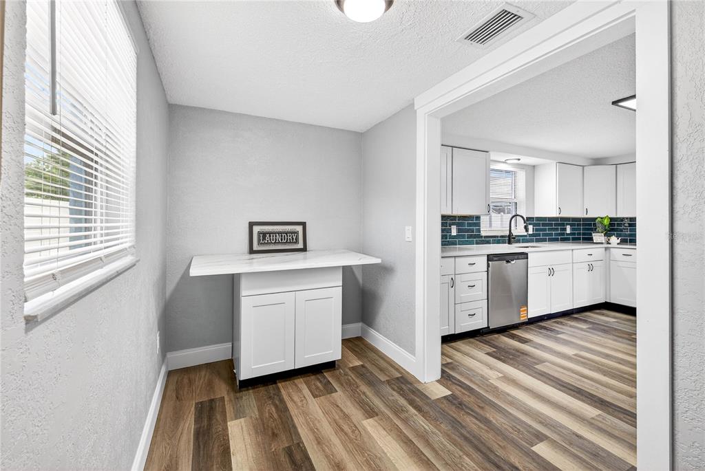 11214 Kapok Avenue Port Richey, FL 34668 - Photo 15 of 25 a kitchen with a white cabinets and white appliances
