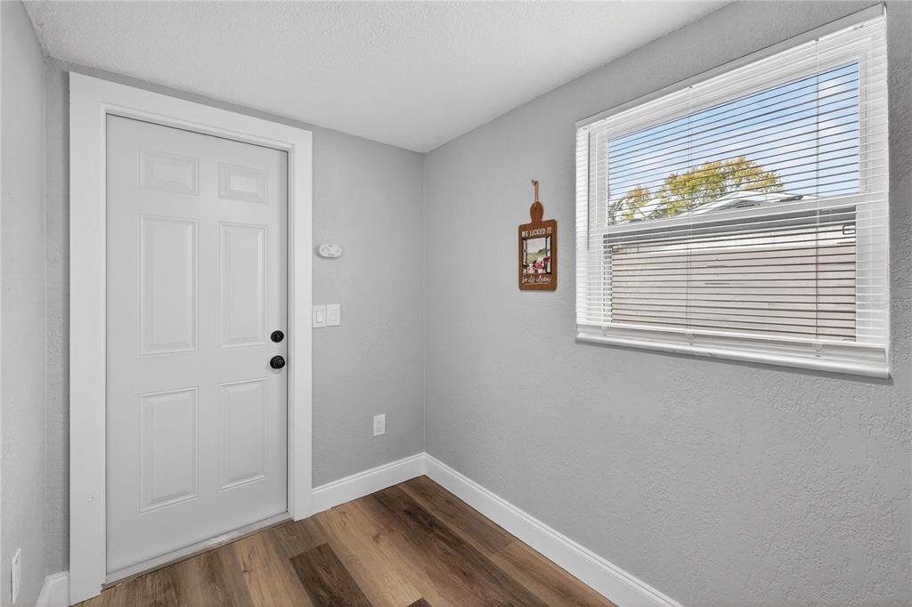 11214 Kapok Avenue Port Richey, FL 34668 - Photo 16 of 25 a view of a small space with wooden floor and a window