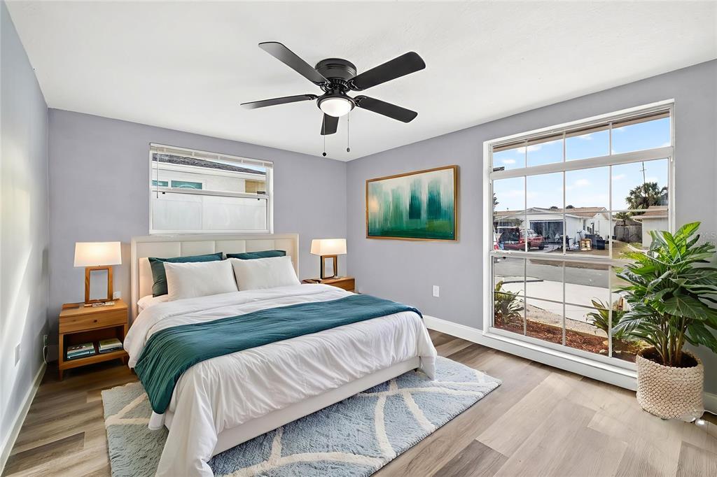 11214 Kapok Avenue Port Richey, FL 34668 - Photo 17 of 25 a bedroom with a large bed and a window