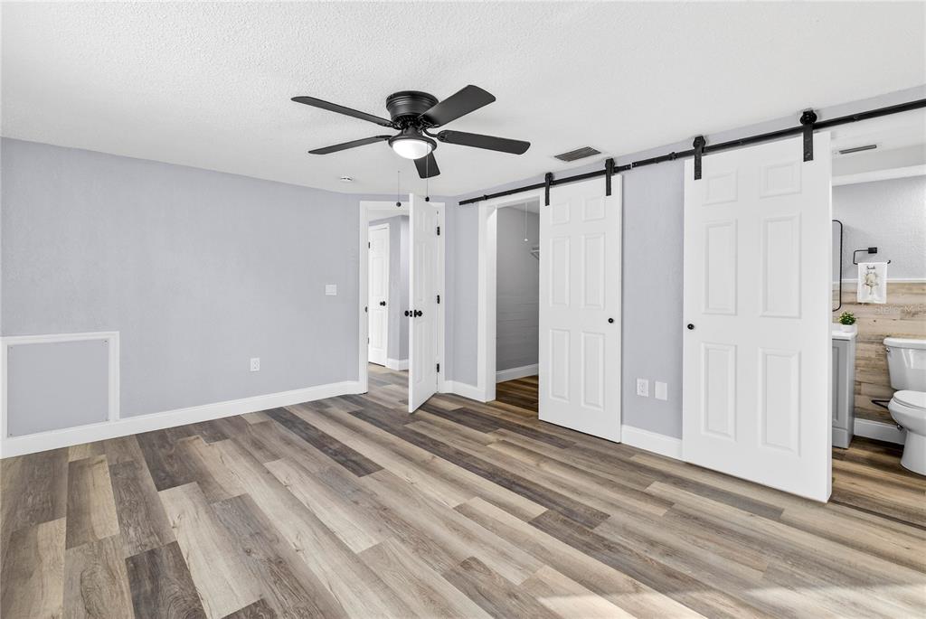 11214 Kapok Avenue Port Richey, FL 34668 - Photo 20 of 25 a view of a livingroom with a ceiling fan & entryway